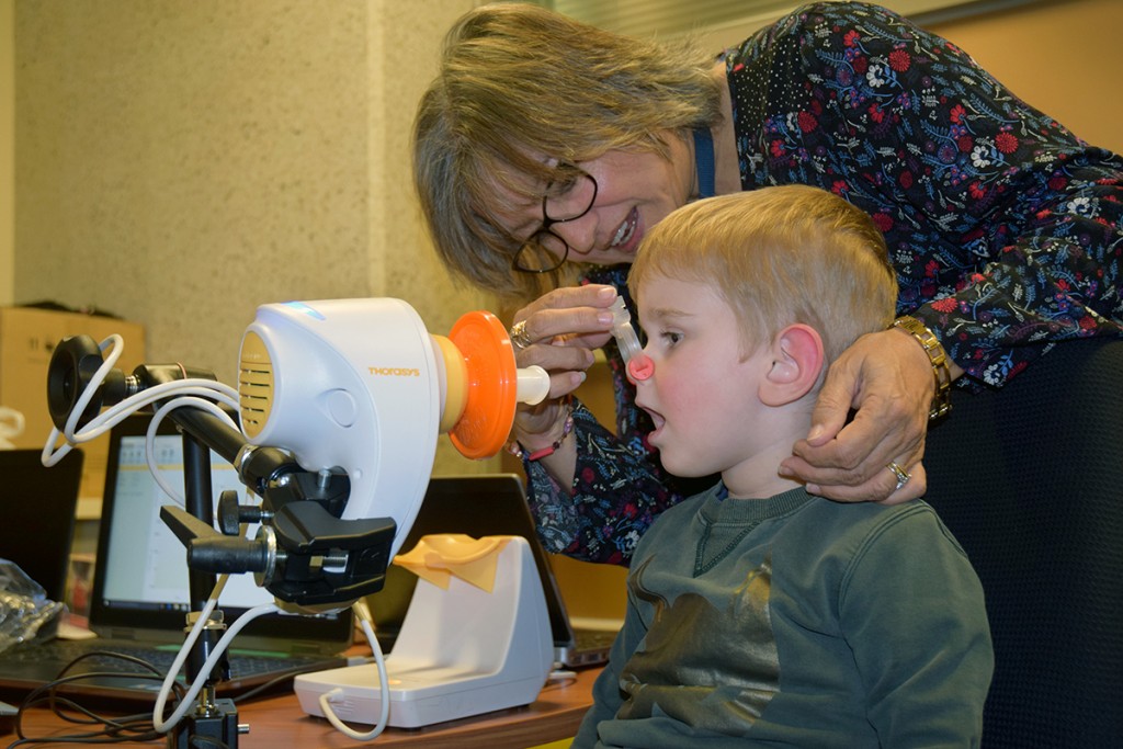 Latrobe Early Life Follow-Up project officer Melanie Reeves helps Branigan Kitwood with a simple breathing check. 